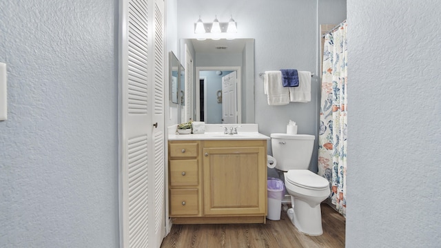 bathroom featuring hardwood / wood-style flooring, vanity, and toilet