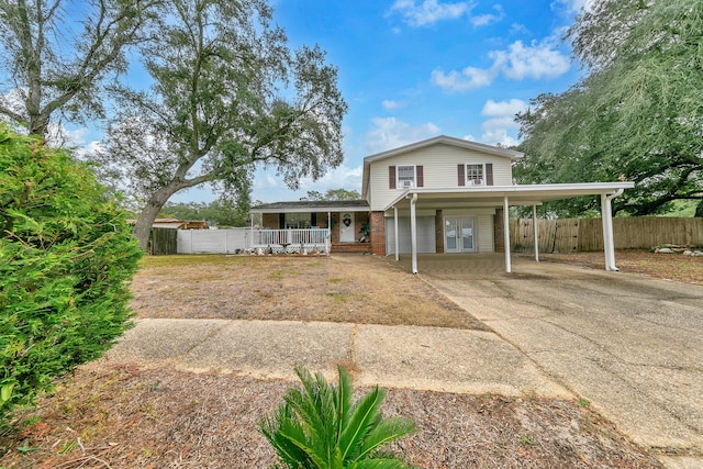 view of front of home featuring a porch and a carport