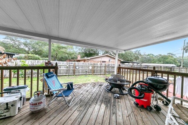 deck with a lawn, grilling area, and a fire pit