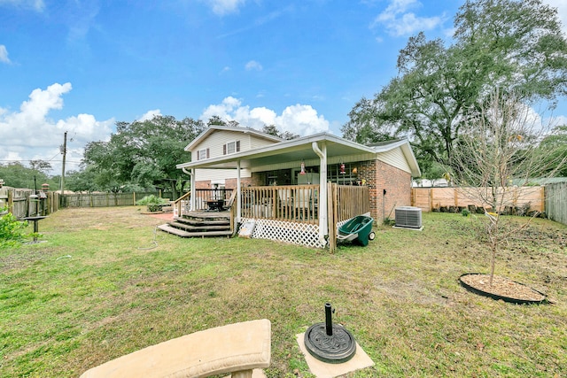 rear view of property featuring a yard, a deck, and cooling unit