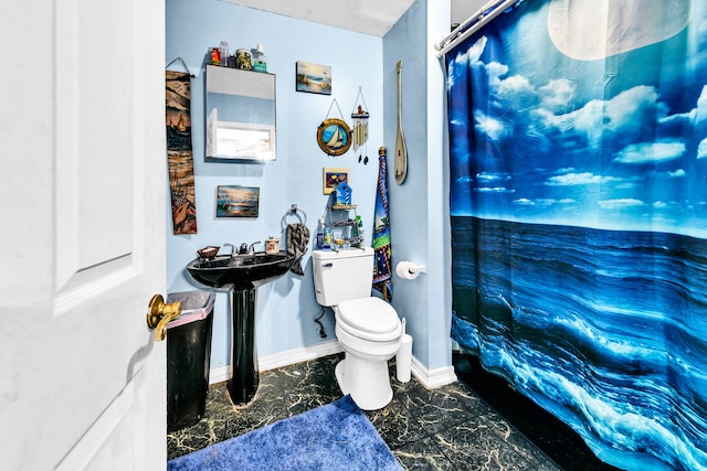 bathroom with curtained shower and toilet