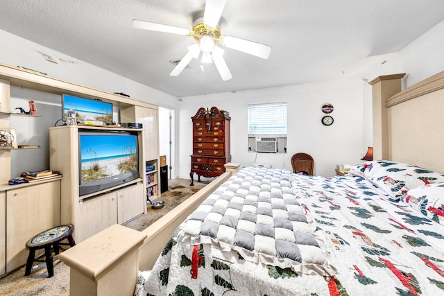 bedroom with carpet, ceiling fan, cooling unit, and a textured ceiling