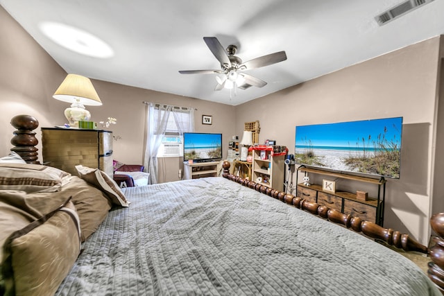 bedroom with ceiling fan and cooling unit