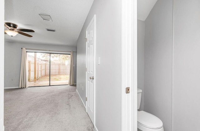 bathroom featuring ceiling fan, toilet, and a textured ceiling