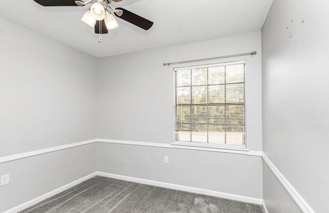 spare room featuring carpet, ceiling fan, and a textured ceiling