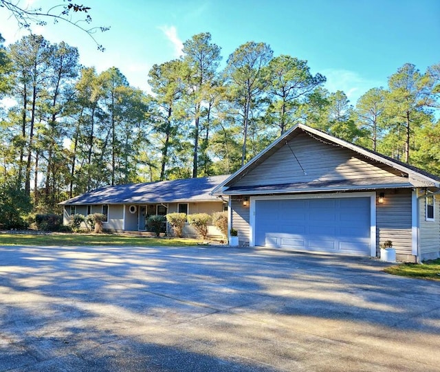 single story home featuring a garage