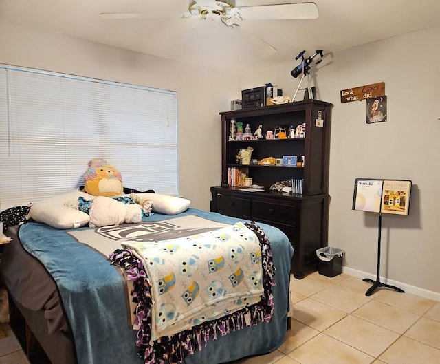 bedroom featuring light tile patterned floors, baseboards, and a ceiling fan