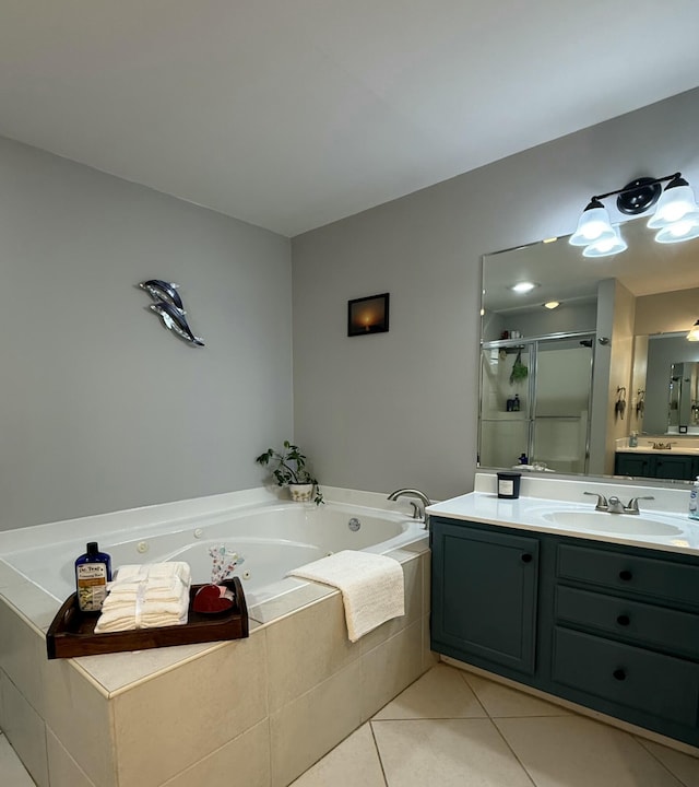 bathroom with a shower stall, vanity, a tub with jets, and tile patterned floors