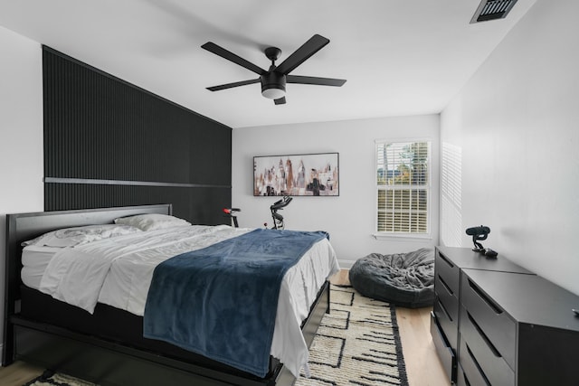 bedroom with light hardwood / wood-style floors and ceiling fan