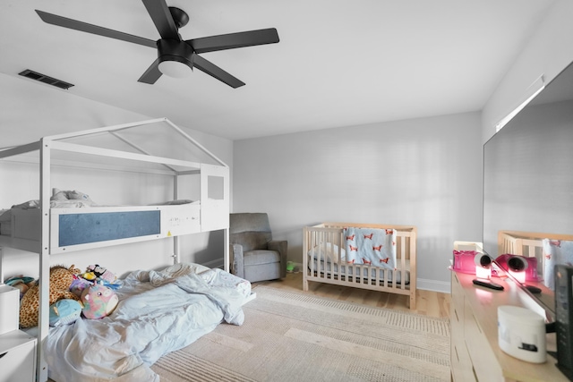 bedroom with ceiling fan and light hardwood / wood-style flooring