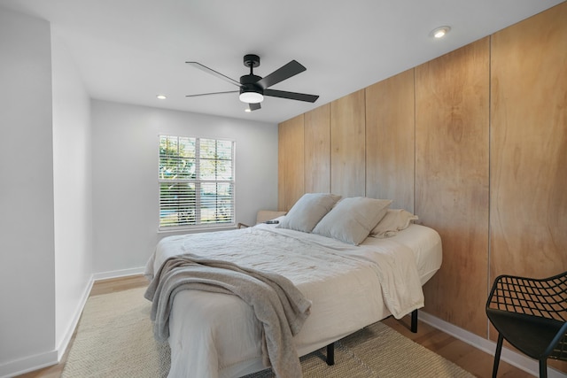 bedroom with light hardwood / wood-style floors and ceiling fan