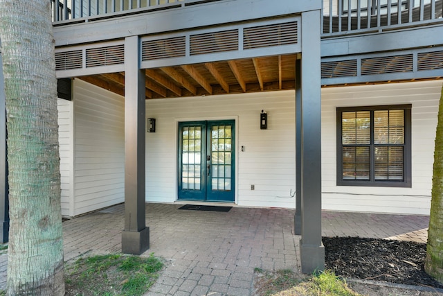 entrance to property featuring french doors and a patio