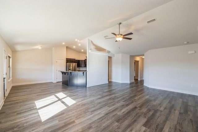 unfurnished living room with vaulted ceiling, ceiling fan, and dark wood-type flooring