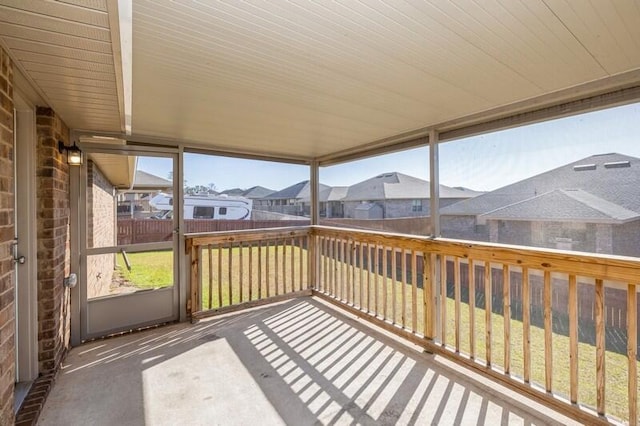 unfurnished sunroom with wood ceiling