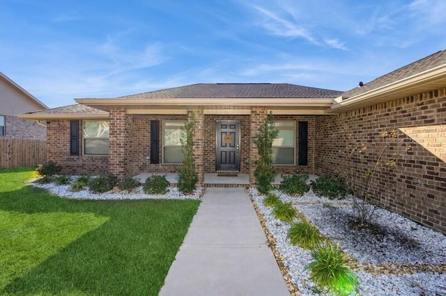 view of exterior entry featuring a yard