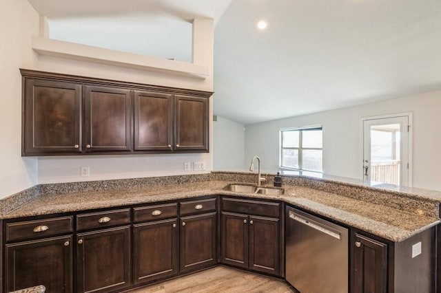 kitchen featuring dishwasher, lofted ceiling, sink, light wood-type flooring, and dark brown cabinetry