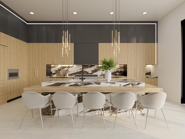 kitchen featuring oven, decorative light fixtures, and a kitchen island