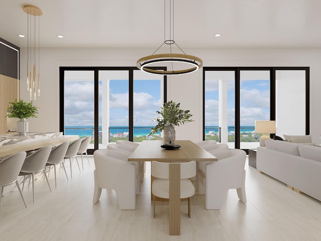 tiled dining room with a notable chandelier and a water view