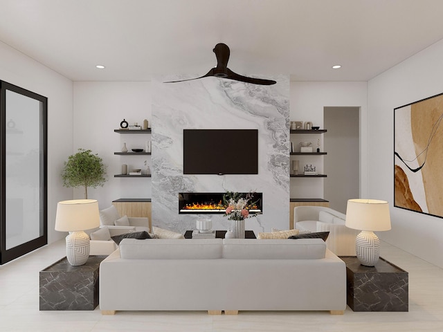 living room with ceiling fan and a premium fireplace