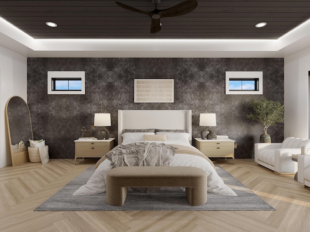 bedroom featuring a raised ceiling, ceiling fan, and light parquet floors