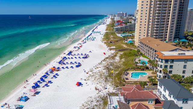 drone / aerial view featuring a water view and a view of the beach