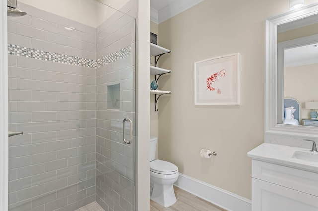 bathroom with toilet, hardwood / wood-style flooring, an enclosed shower, ornamental molding, and vanity