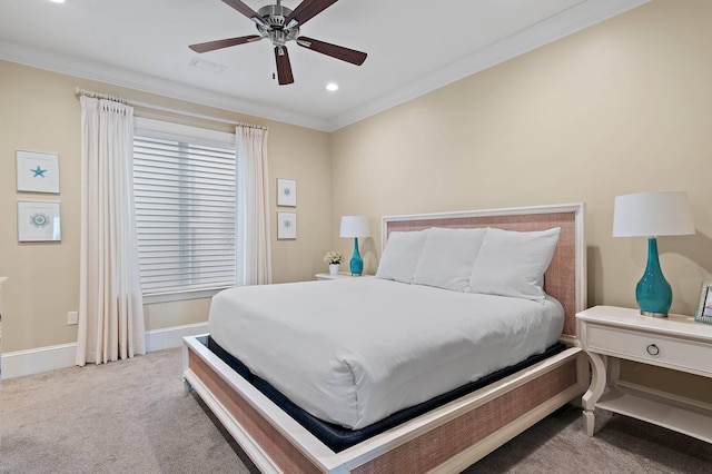 carpeted bedroom featuring ceiling fan and crown molding