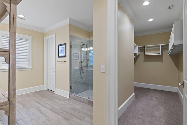 bathroom with walk in shower and crown molding