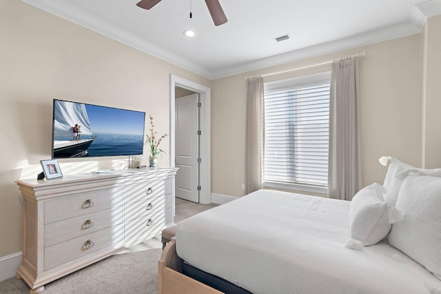 bedroom with ceiling fan, ornamental molding, and light carpet