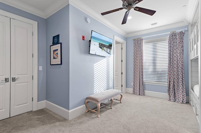 interior space with ceiling fan, light colored carpet, and crown molding