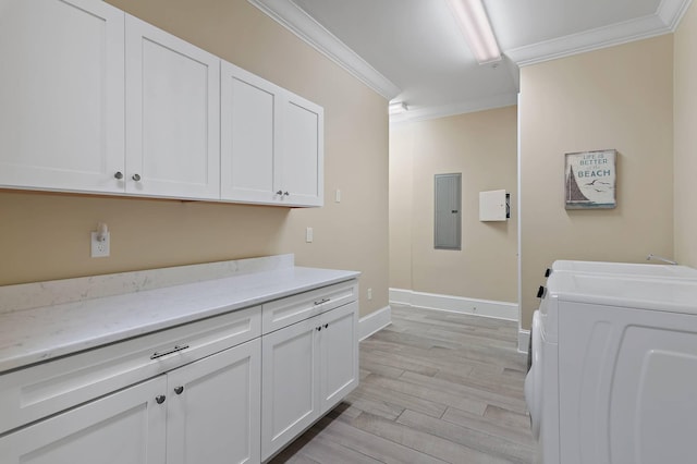 washroom with cabinets, electric panel, crown molding, and washing machine and clothes dryer