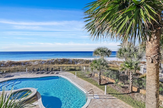 view of pool with a water view