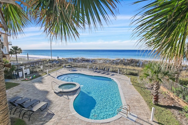 view of swimming pool featuring a water view and a community hot tub