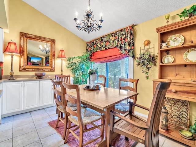 tiled dining room with a textured ceiling, an inviting chandelier, and lofted ceiling