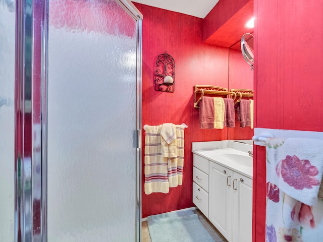 bathroom featuring vanity and an enclosed shower