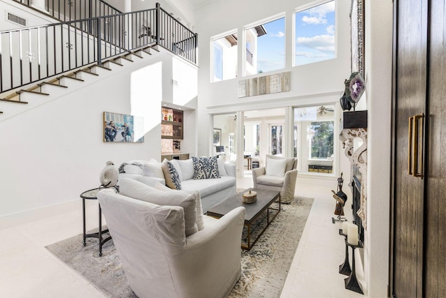 tiled living room featuring a high ceiling and a wealth of natural light