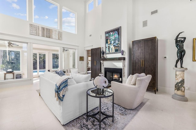 living room featuring a high ceiling and ceiling fan