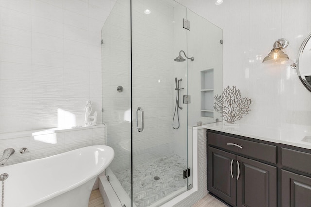 bathroom featuring separate shower and tub and tile walls