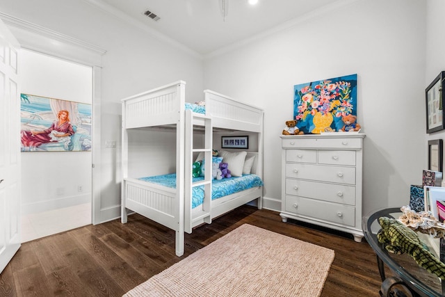 bedroom featuring crown molding and dark wood-type flooring