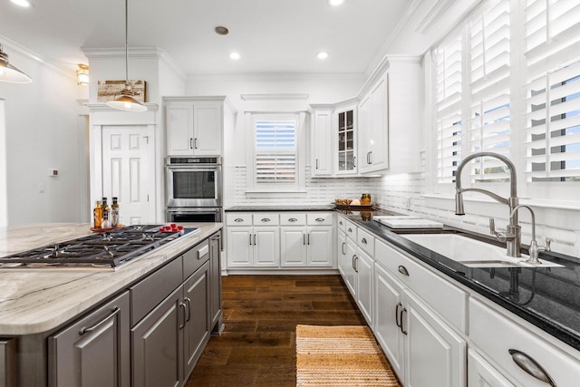 kitchen with sink, stainless steel appliances, dark hardwood / wood-style flooring, dark stone countertops, and white cabinets