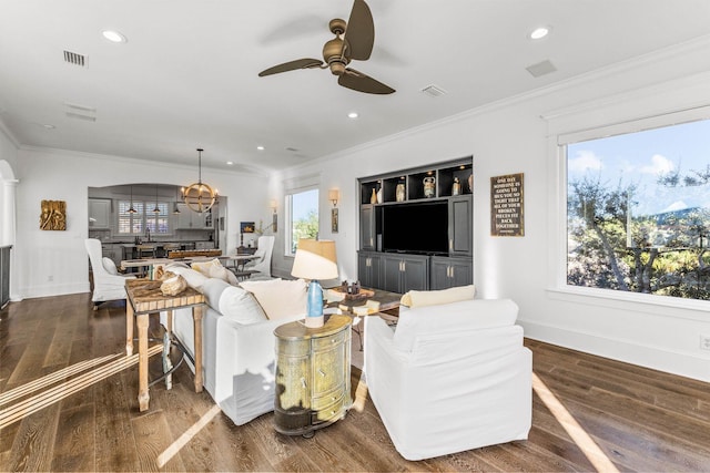 living room featuring ceiling fan, dark wood-type flooring, and ornamental molding