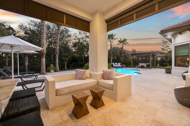 patio terrace at dusk featuring an outdoor living space and a pergola