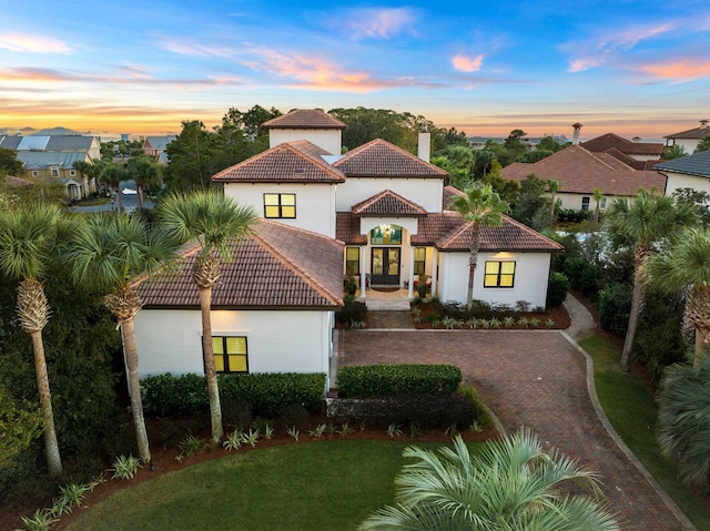 mediterranean / spanish-style house with a yard