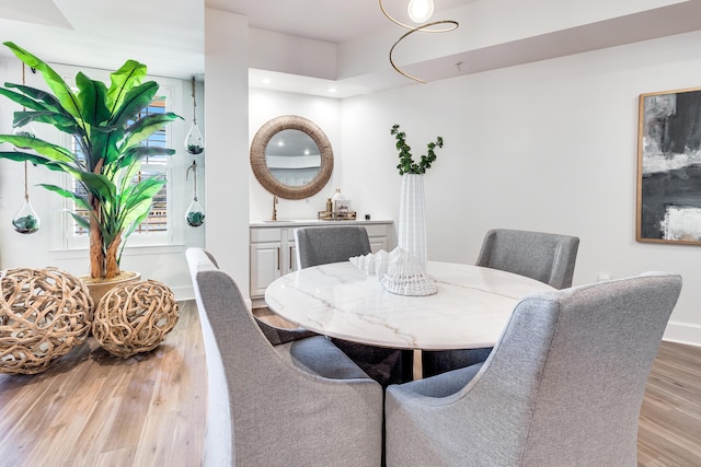 dining space with light hardwood / wood-style floors