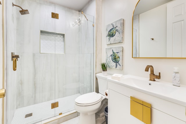 bathroom with vanity, an enclosed shower, and toilet