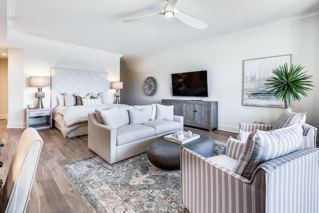 bedroom with hardwood / wood-style floors, ceiling fan, and ornamental molding