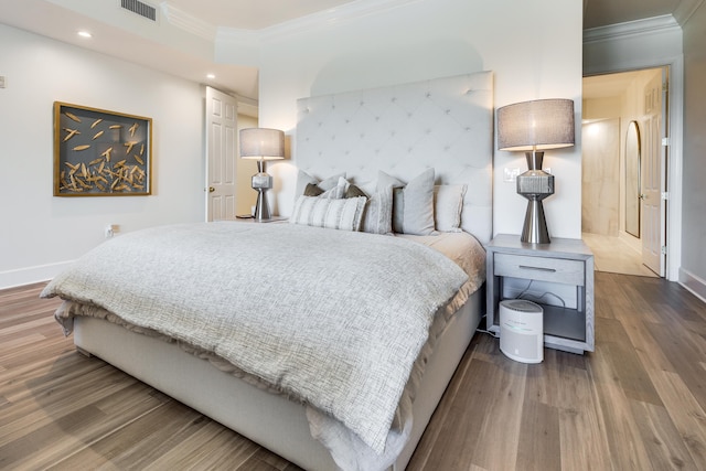 bedroom featuring hardwood / wood-style floors and ornamental molding