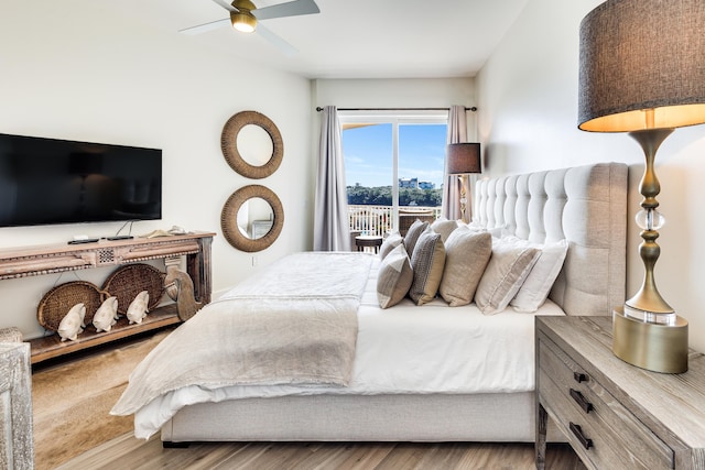 bedroom with hardwood / wood-style floors, access to outside, and ceiling fan