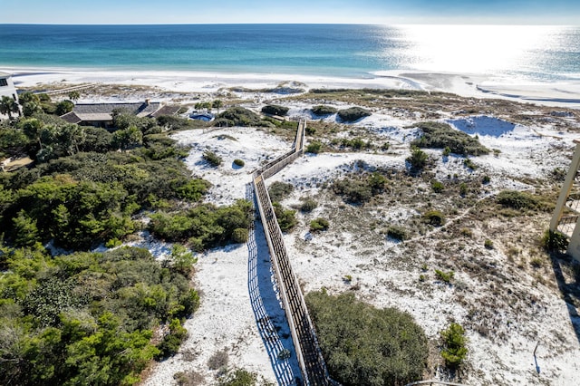 birds eye view of property with a water view and a beach view