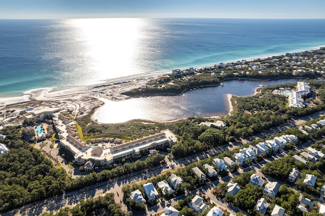 birds eye view of property with a water view and a view of the beach